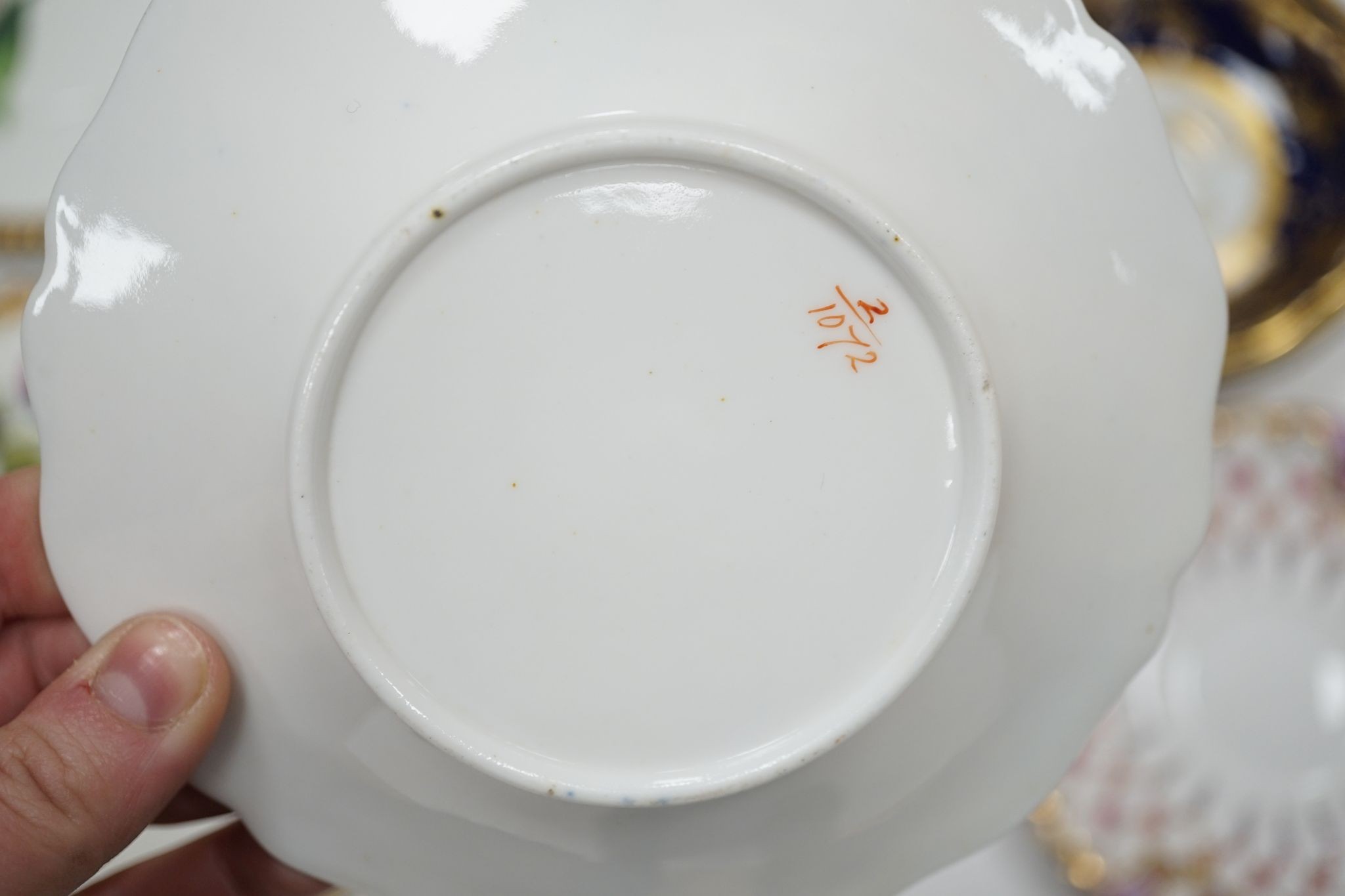 A small collection of Victorian porcelain tea cups and saucers and sundry dessert plates